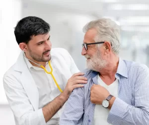 A male healthcare provider tending to his patient