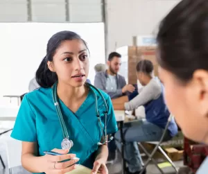 A healthcare provider explains a procedure to her patients using inclusive language
